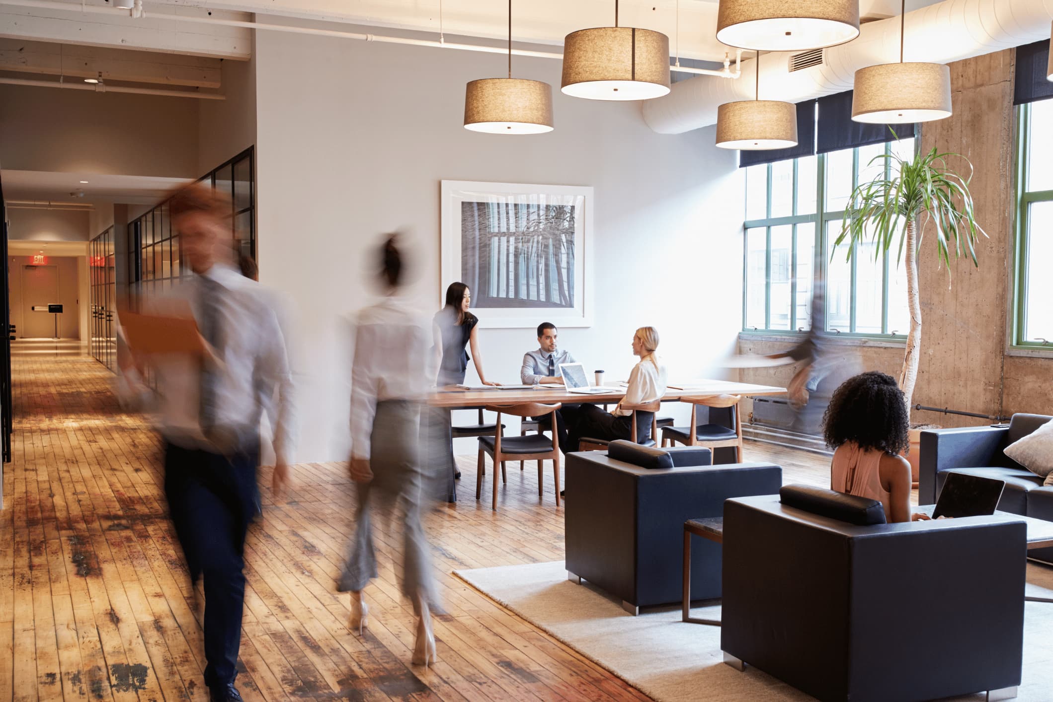 Office environment with blurred people walking through it.