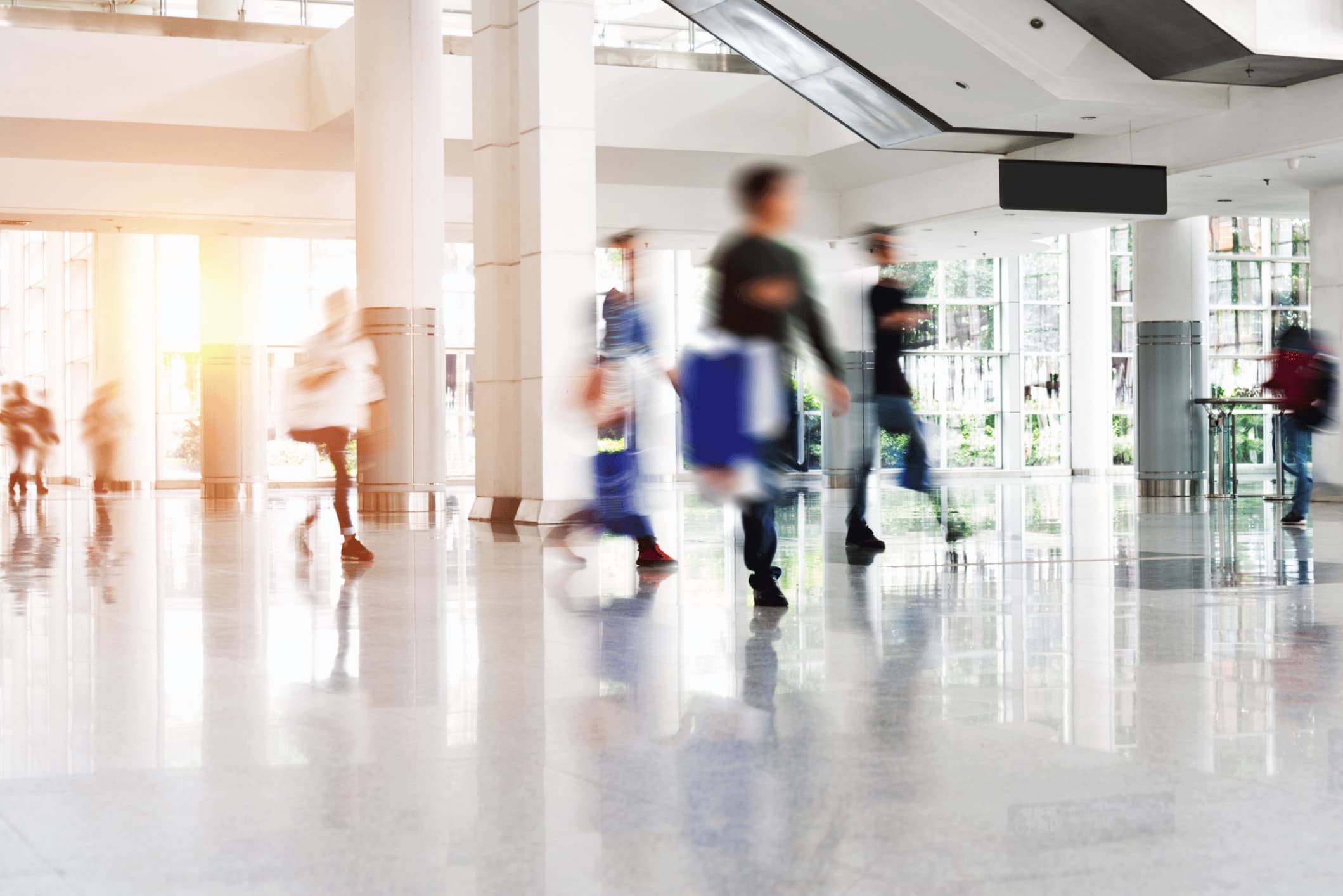 Blurred people walking in a modern office.