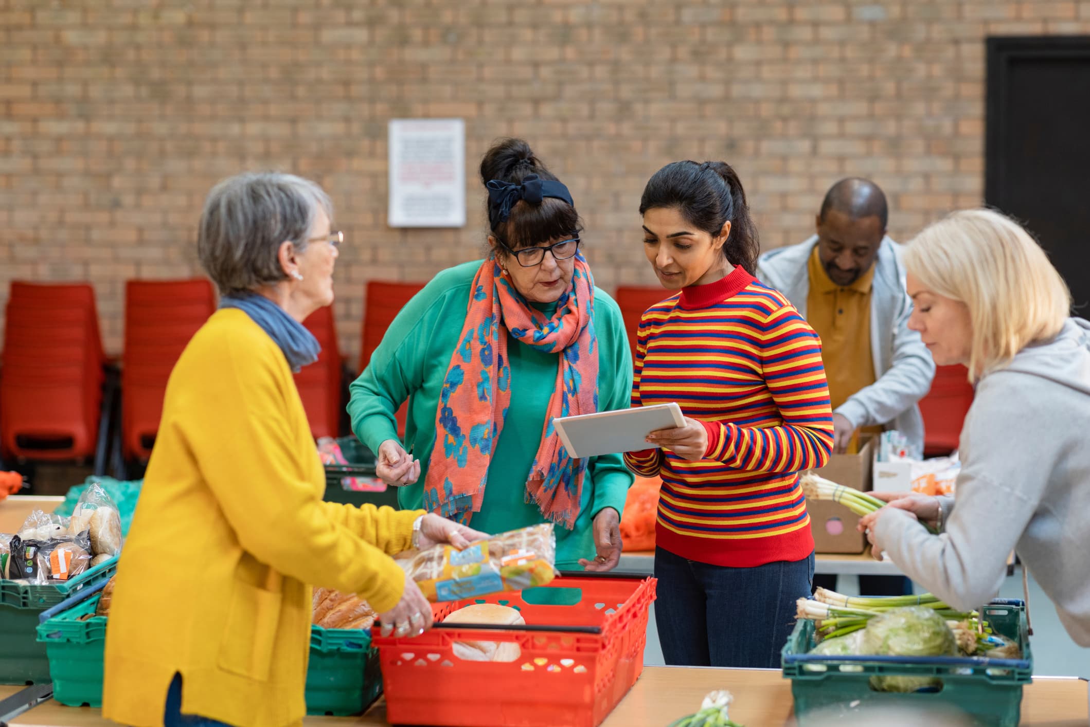 Four women organising a food donation drive.